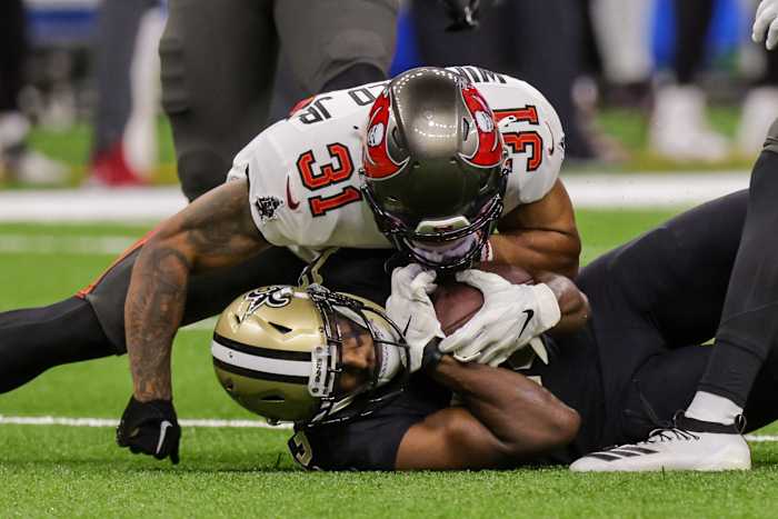 Sep 18, 2022; New Orleans, Louisiana, USA; Tampa Bay Buccaneers safety Antoine Winfield Jr. (31) tackles New Orleans Saints wide receiver Michael Thomas (13) during the first half at Caesars Superdome. Mandatory Credit: Stephen Lew-USA TODAY Sports